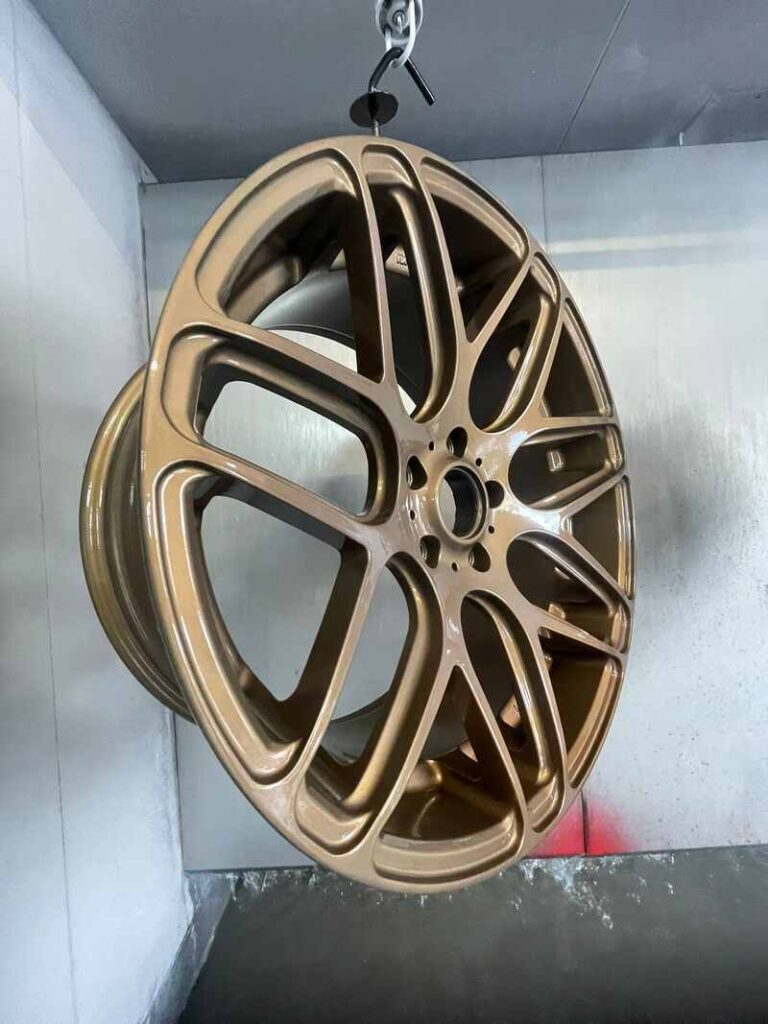 Local alloy wheel specialist inspecting wheels in a Barnsley garage